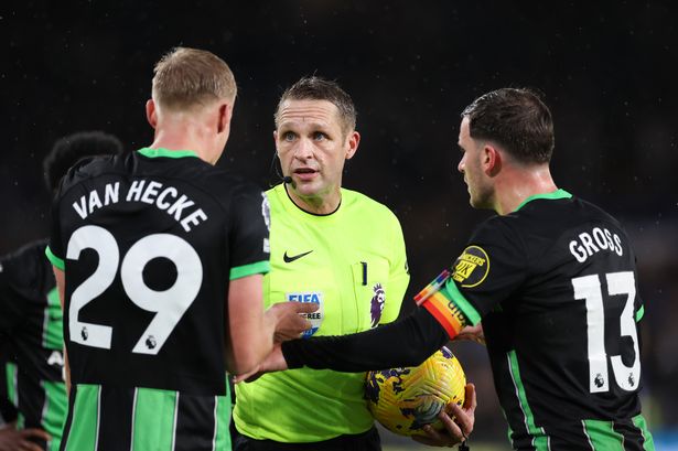 Match referee Craig Pawson argues with Brighton players after denying them a last minute penalty during the Premier League match between Chelsea FC and Brighton & Hove Albion at Stamford Bridge on December 3, 2023 in London, England.